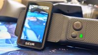 An SJCAM C400 on a wooden surface