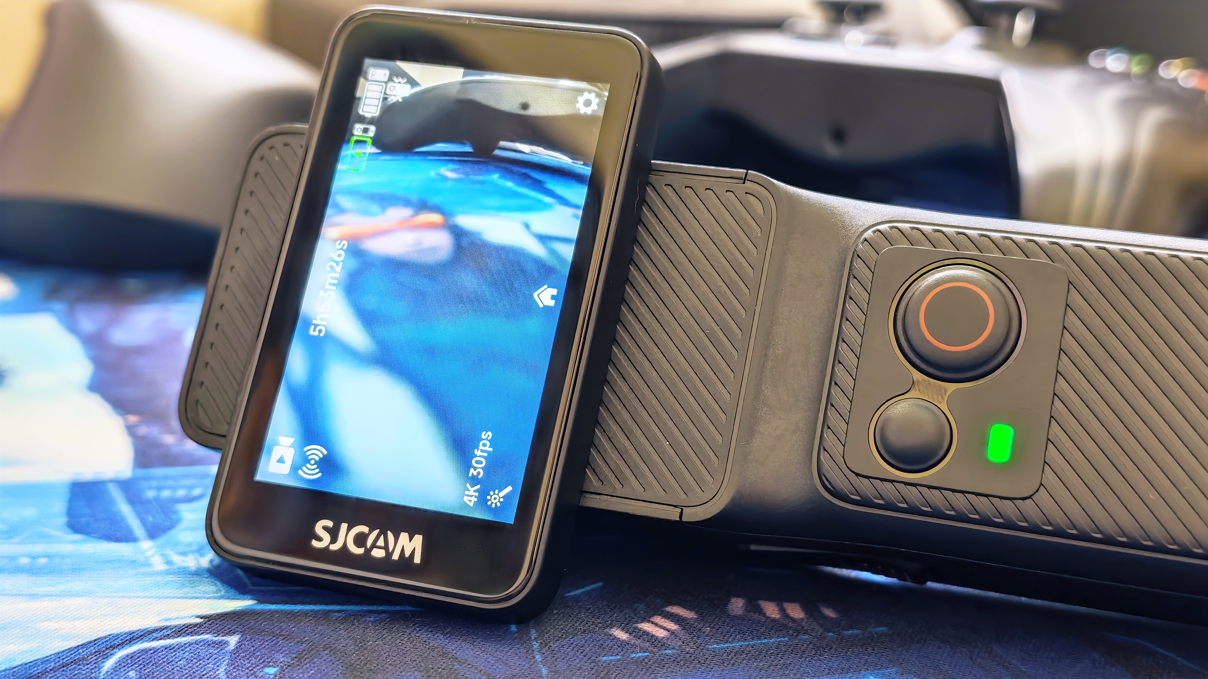 An SJCAM C400 on a wooden surface