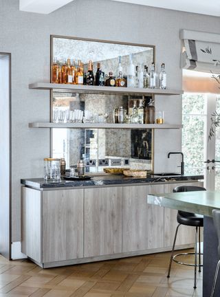 Home bar with open shelving and silver birch wood cabinetry