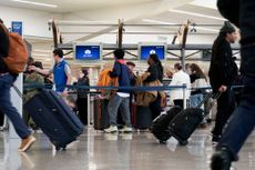 Travelers wait in line at Hartsfield-Jackson Atlanta International Airport (ATL) in Atlanta, Georgia