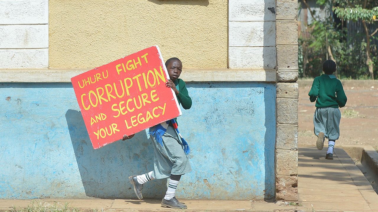 Schoolchildren from the Lang&amp;#039;ata road primary flee tear gas on January 19, 2015 in Nairobi after breaking a wall illegally erected around it and being dispersed by police attempting to break 