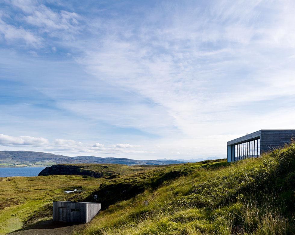 A self build in Skye with a low lying roof which blends into the landscape