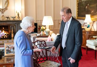 Queen Elizabeth II presents English concert organist Thomas Trotter with the Queen's Medal for Music, during an audience at Windsor Castle
