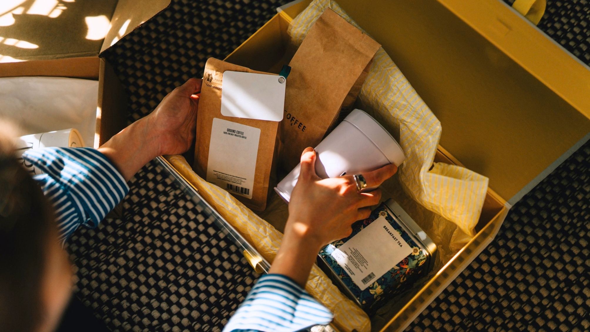 Close-up of young woman unpacking subscription box