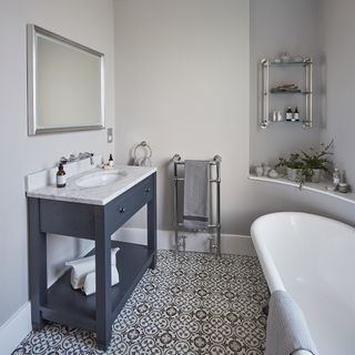 bathroom with printed tiled flooring and white bathtub