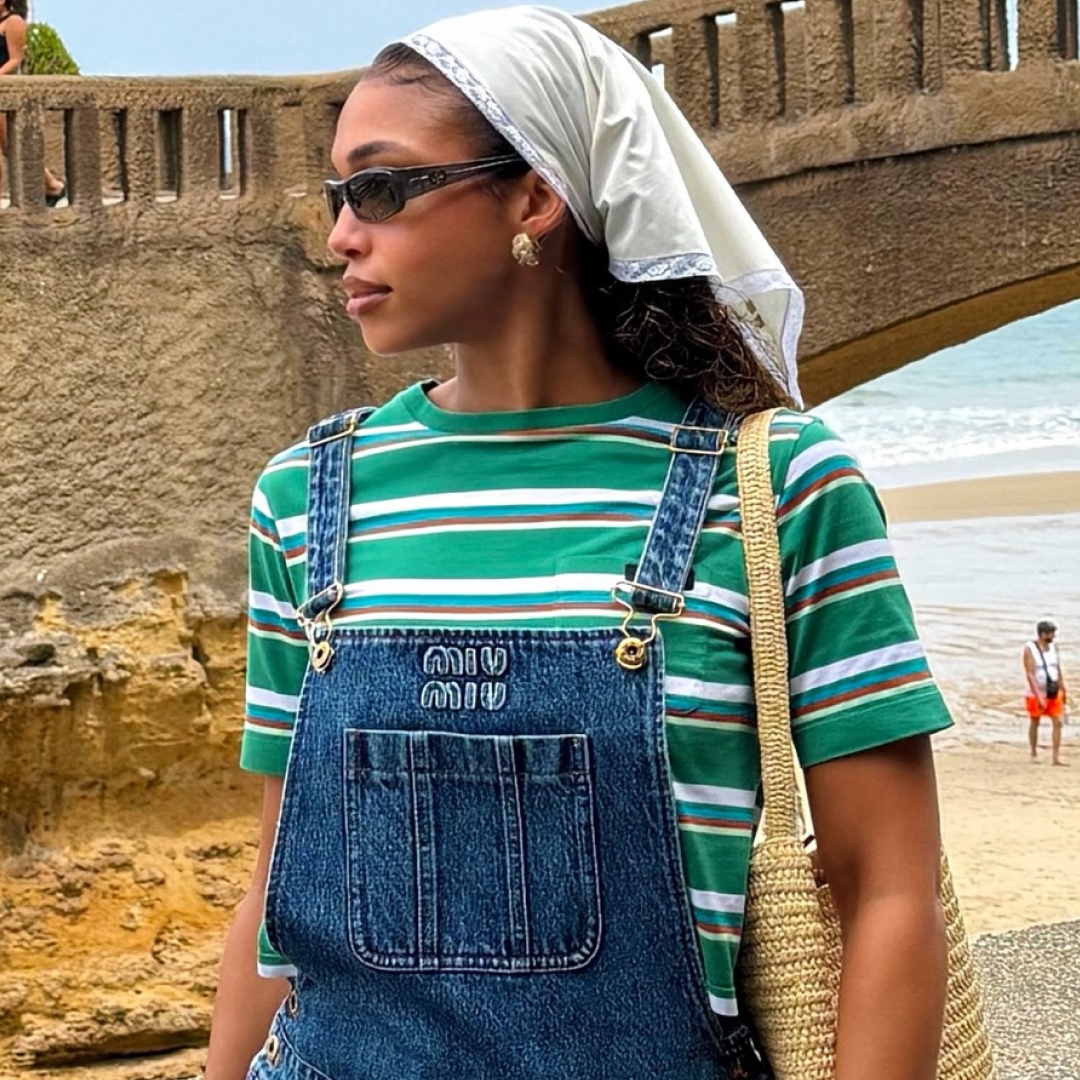 Lori Harvey styled the summer stripes trend with Miu Miu overalls and flip-flops on vacation