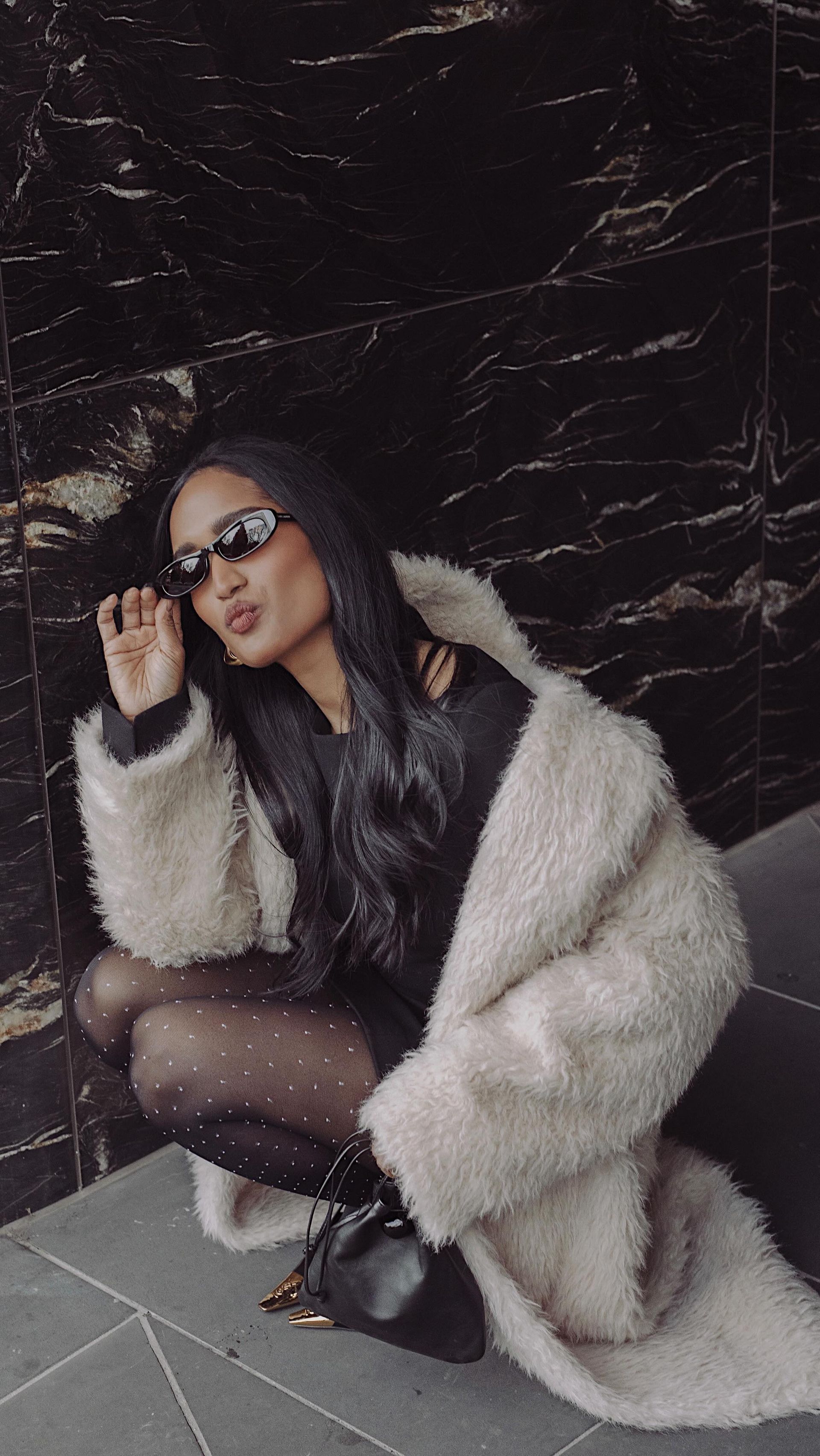 An image of @divrav wearing polka dot tights, one of the biggest winter tight trends of 2025.