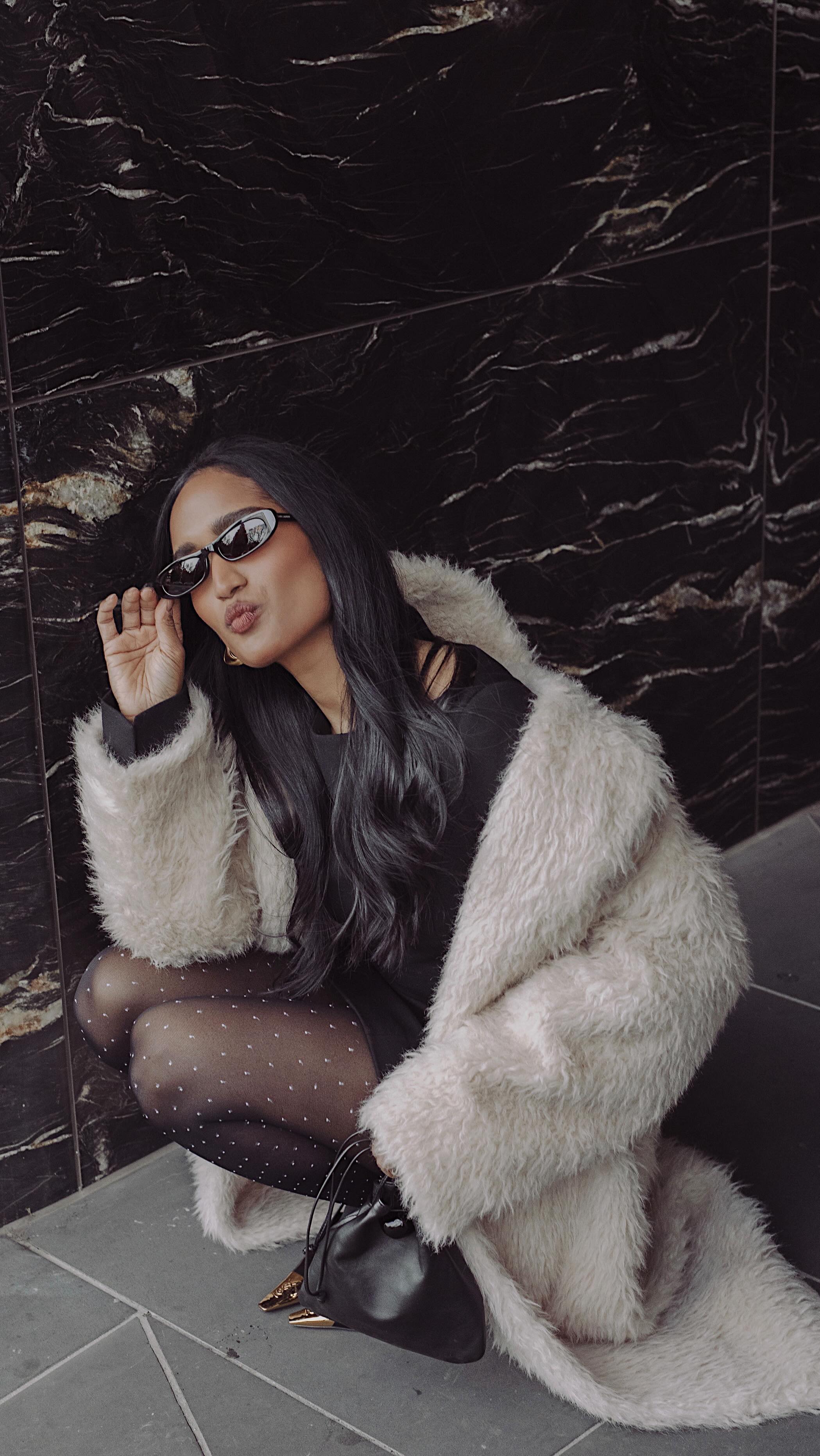 An image of @divrav wearing polka dot tights, one of the biggest winter tight trends of 2025.