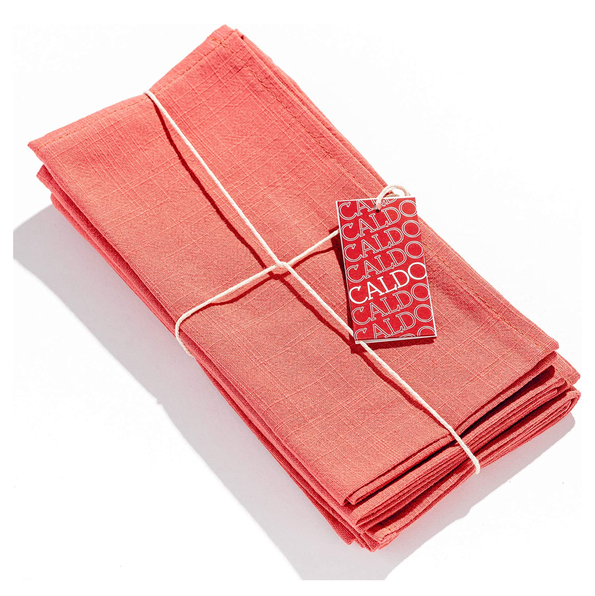 Pack of coral colored linen napkins tied with twine