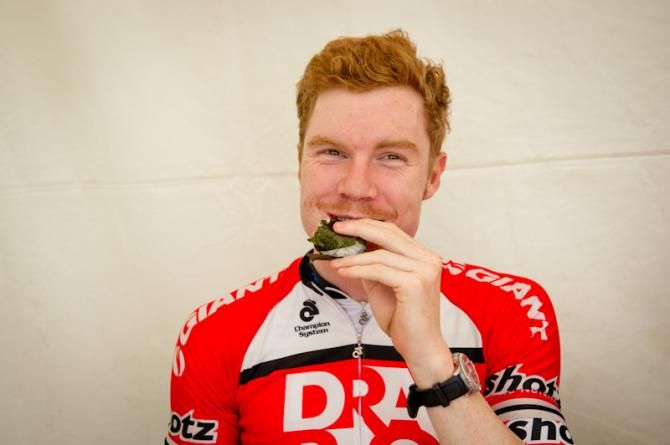 Tom Palmer (Drapac) eating a Japanese Onigiri, a rice ball, before stage 1