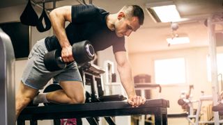 Man doing a dumbbell arm workout at the gym