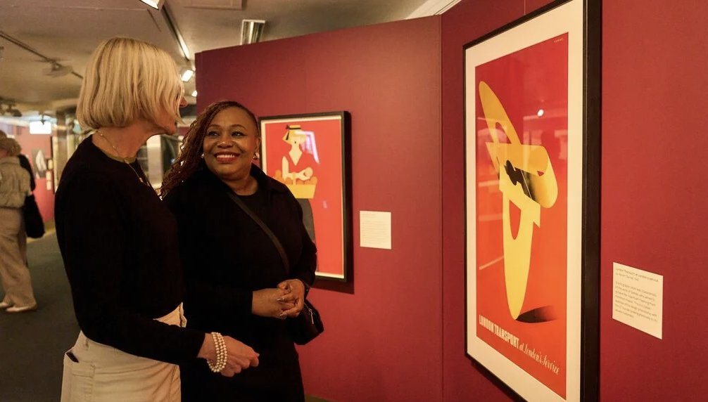 an image of two women looking at the exhibition