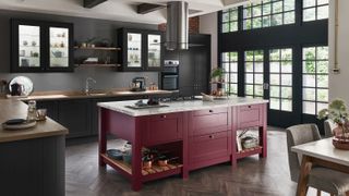 Dark grey kitchen with red kitchen island, metal frame windows and L shape