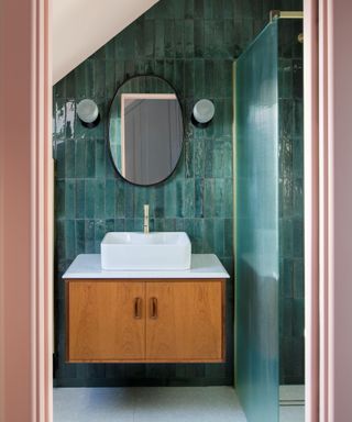colors that go with teal, teal and bathroom with tiled walls, shower, wall mounted vanity, mirror, wall lights, peach painted woodwork