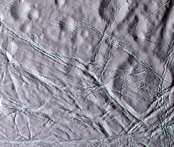 Cassini color image of "snowy" landscape of Enceladus. This terrain lies north of the geologically active south polar ridges and features a rolling terrain crosscut by narrow fractures.