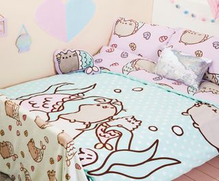 bedroom with purrmaid cuddly cushions and glitter cushoin and throw