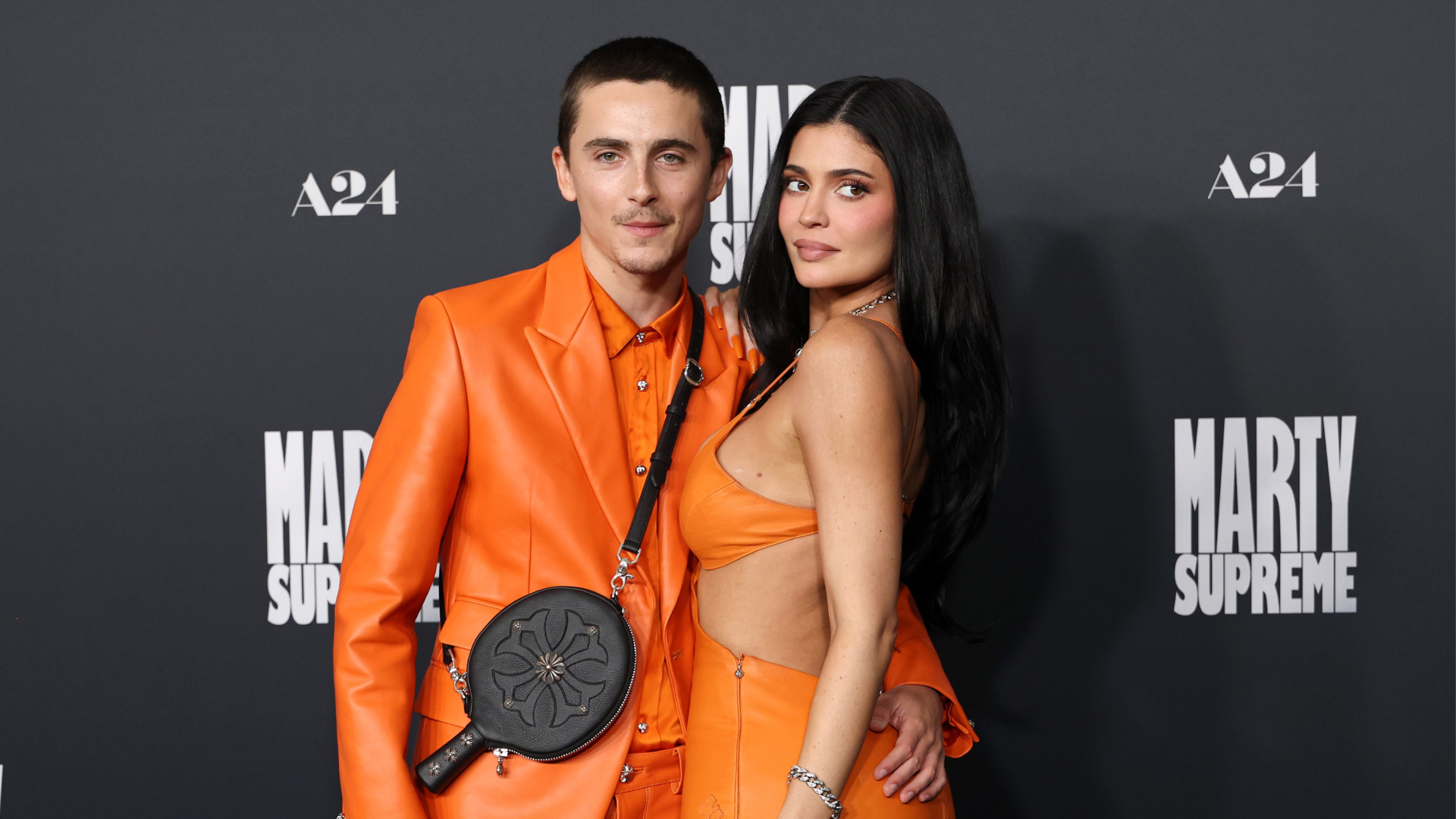 timothee chalamet and kylier jenner wear orange chrome hearts custom leather outfits on the red carpet of the la premiere of marty supreme
