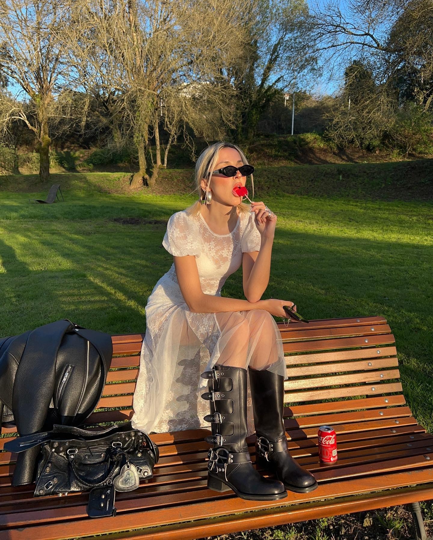 Sofia wears a lace dress and black moto boots.