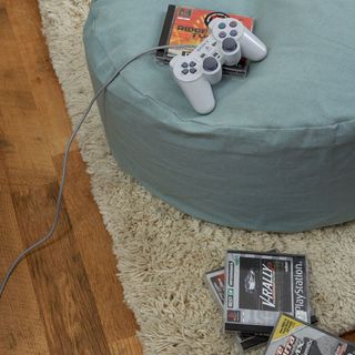 room with wooden flooring and joystick with video game