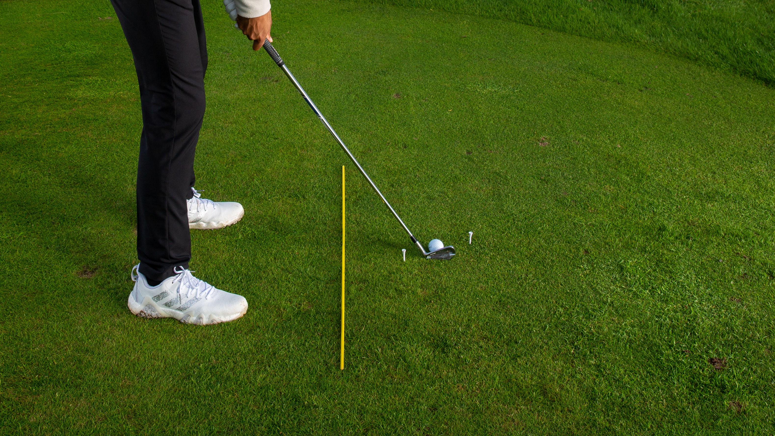 A golfer setting up to hit a shot at The Astbury Golf Resort