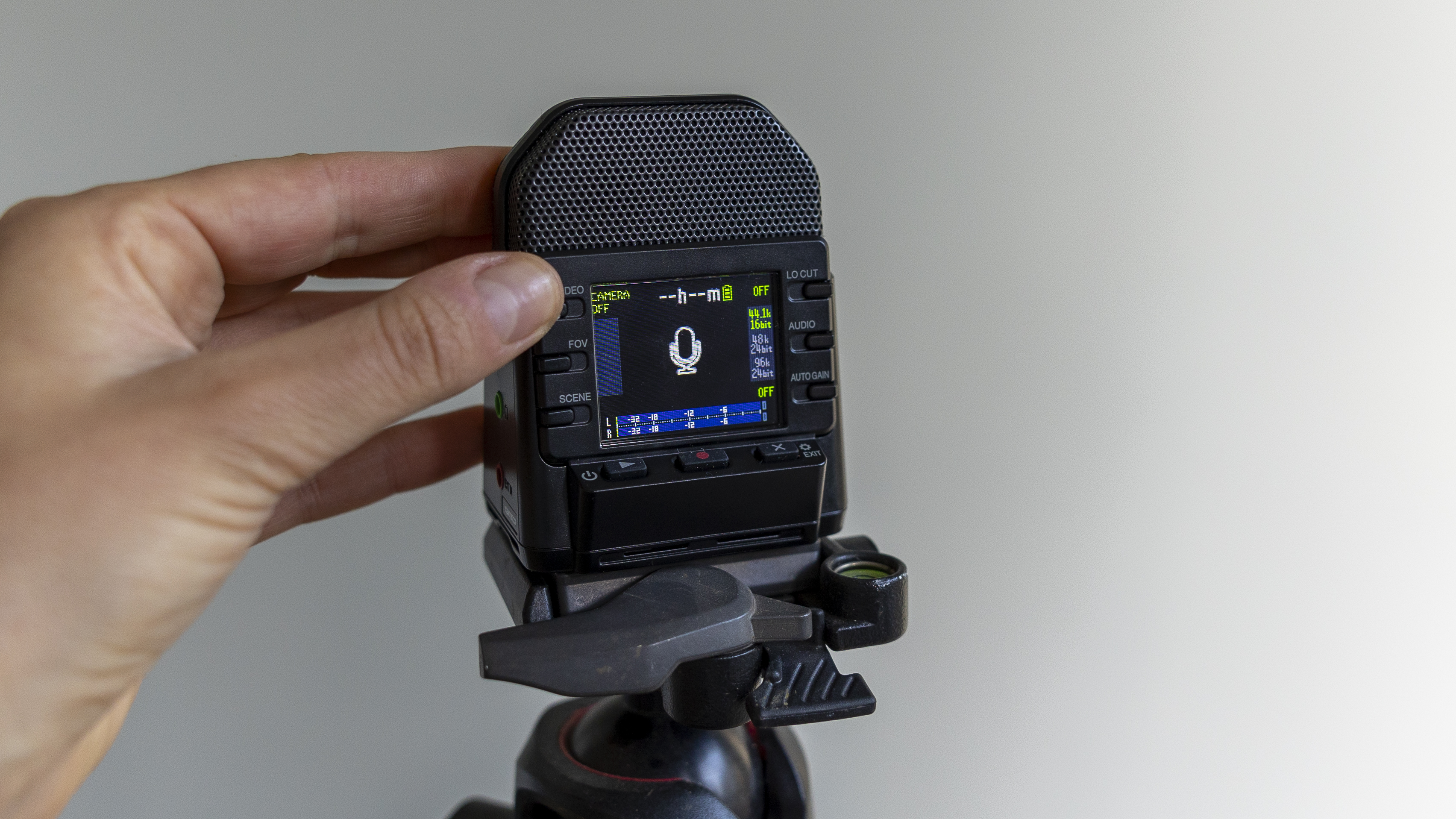 The Zoom Q2N-4K recorder in a light studio against a green wall
