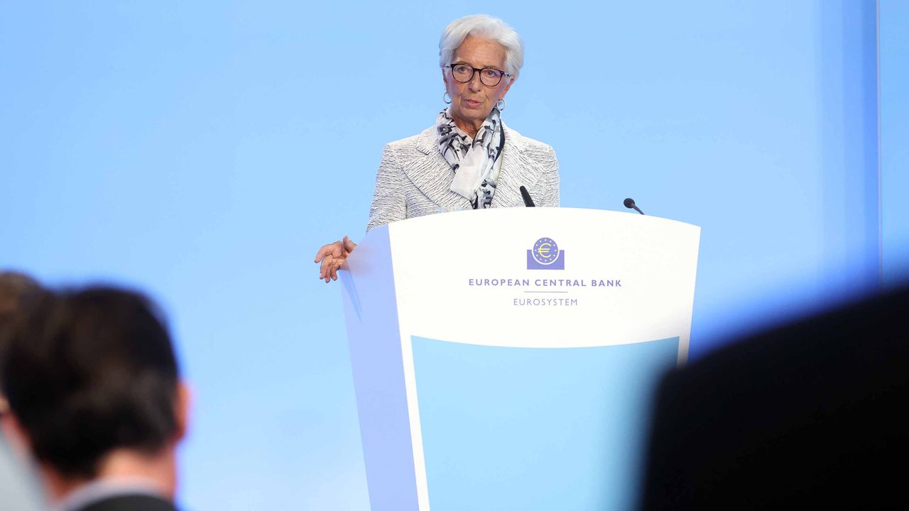 ECB President Christine Lagarde at a white podium with blue background