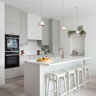 kitchen with white walls and bar stools