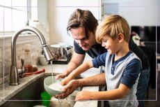 Father and son washing up together