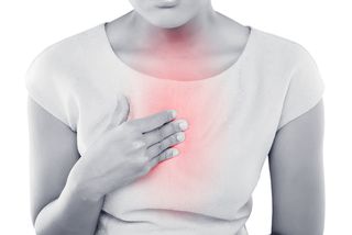 A woman's chest fills with the pain of heartburn