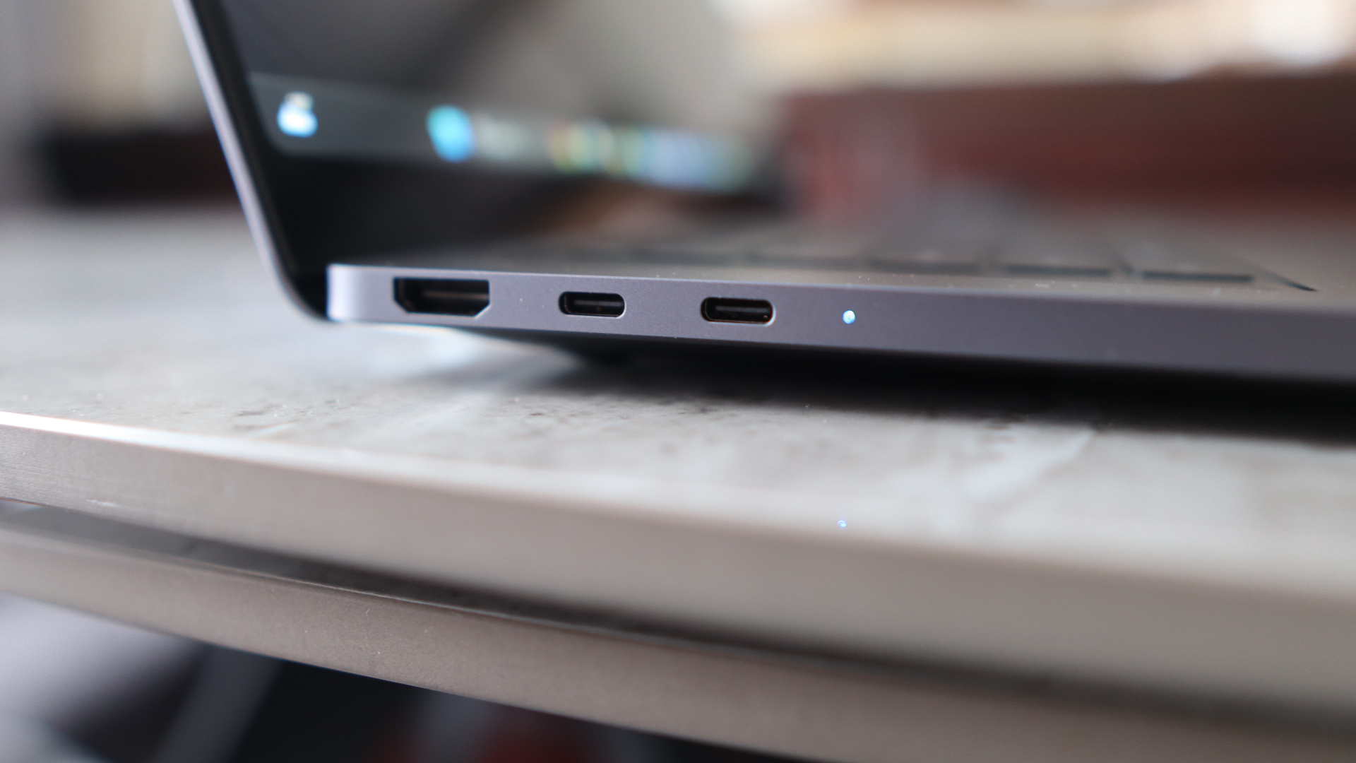 A close-up view of some ports on a grey laptop.