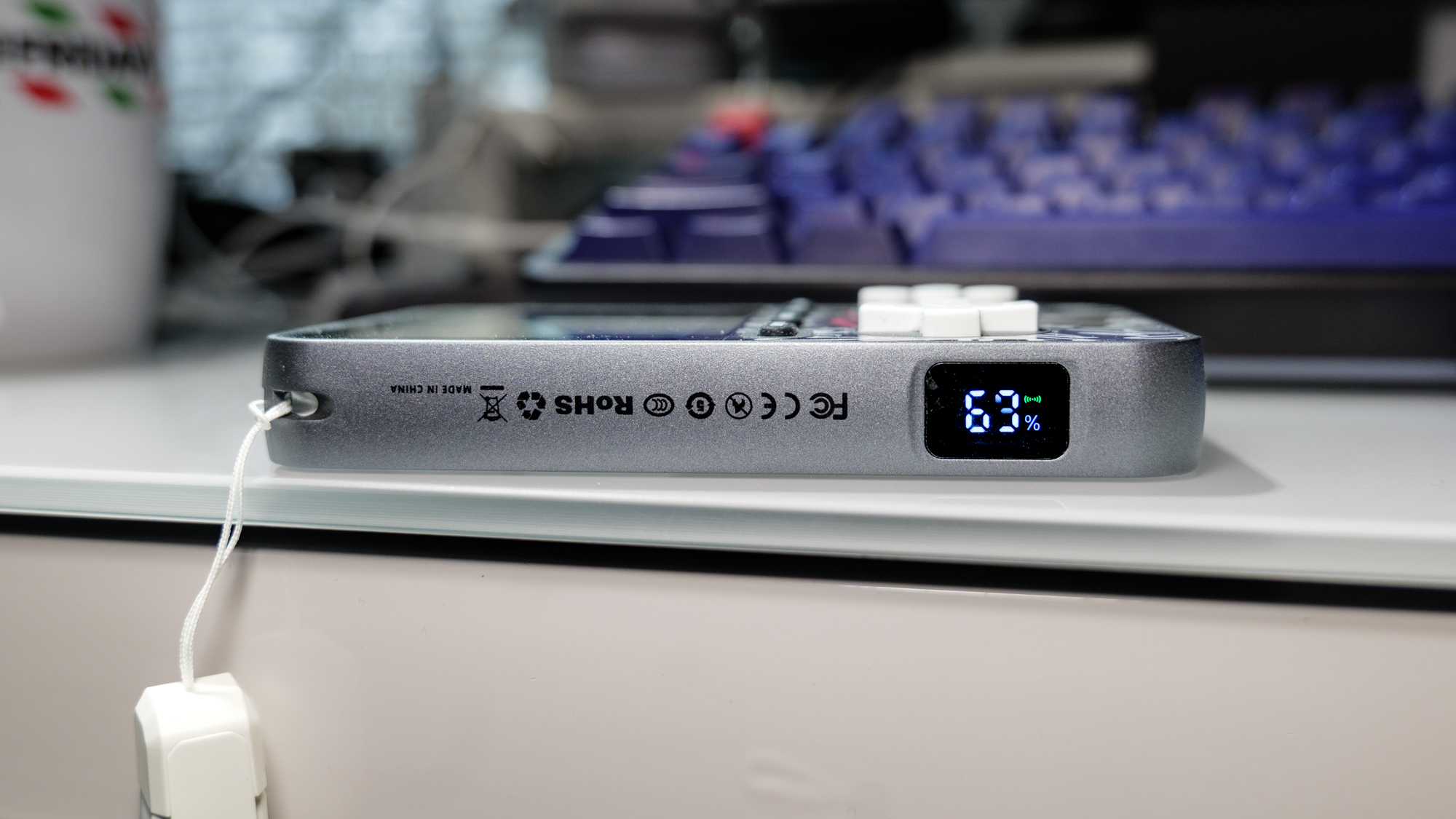 MIRO V99 Power Bank Gaming Console side showing its charge level and lanyard.