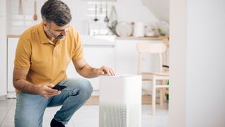 man setting up one of the best air purifiers in his home