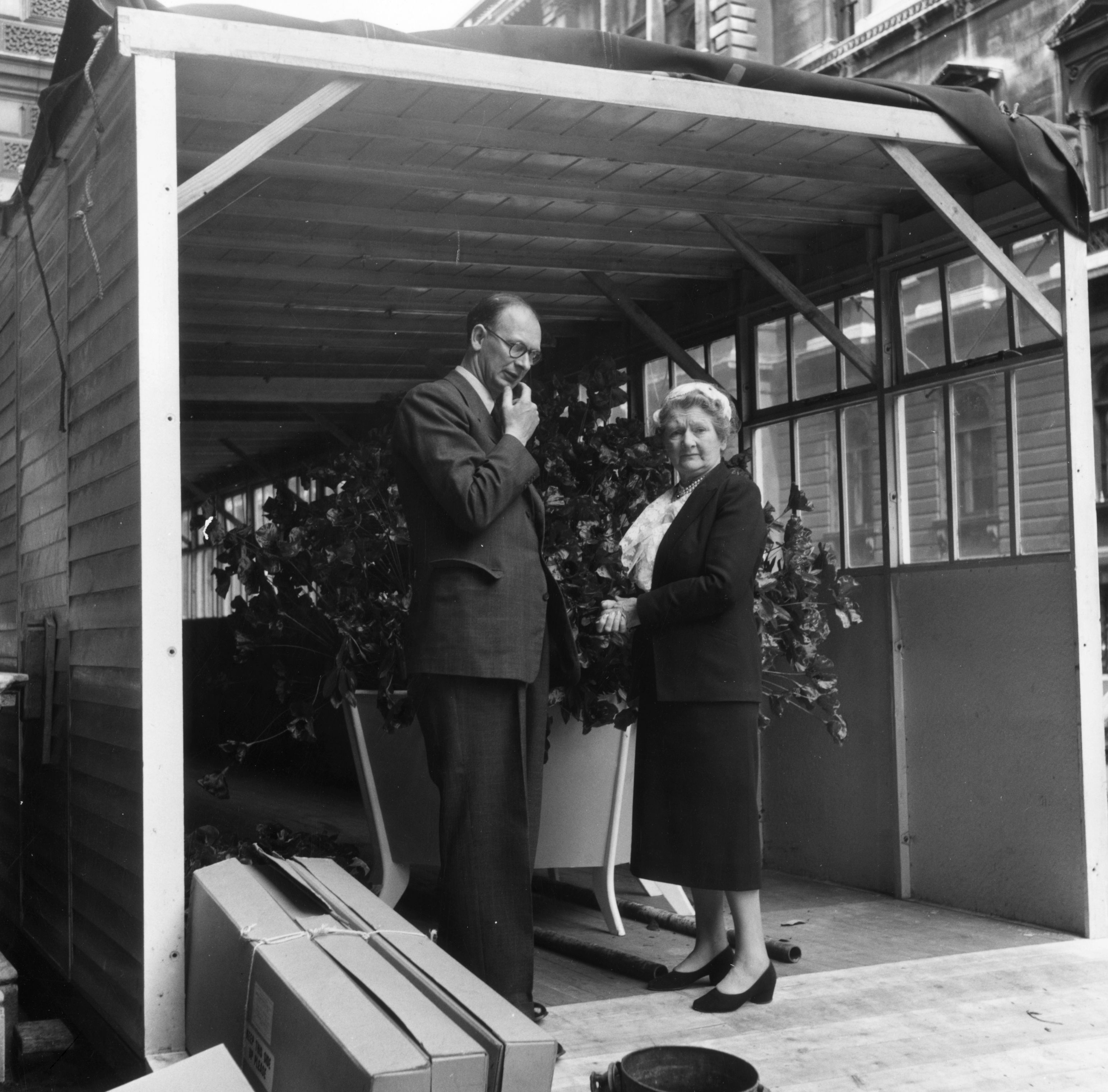 13th June 1953: Eric Bedford, Chief Architect of the Ministry of Works and floral arranger Constance Spry discuss the placement of six tubs of poppies arranged by disabled servicemen for the coronation route of Queen Elizabeth II.