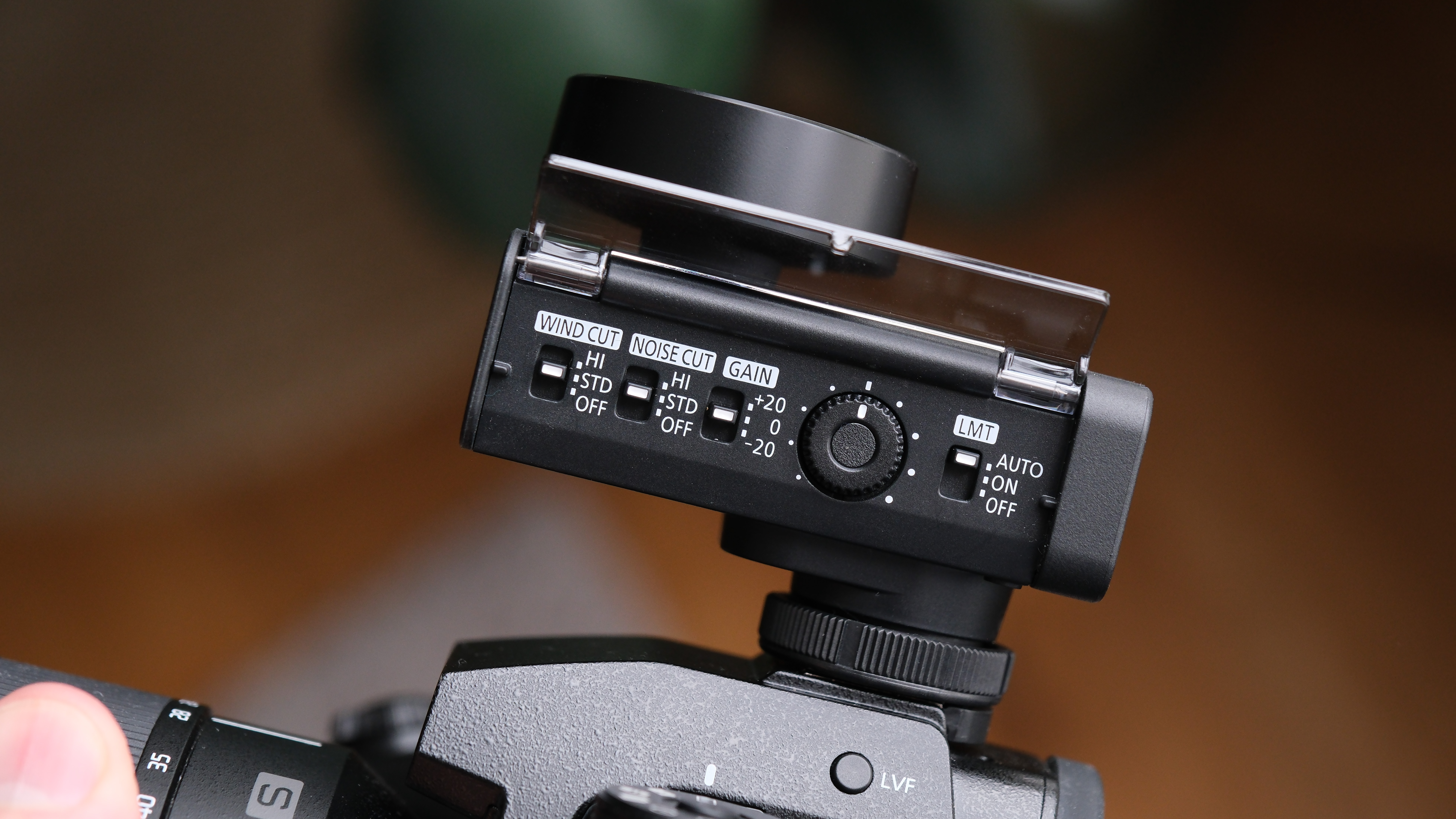 Close-up of the Panasonic Lumix DMW-DMS1 microphone mounted on a Lumix camera, highlighting the top microphone grille and body design.