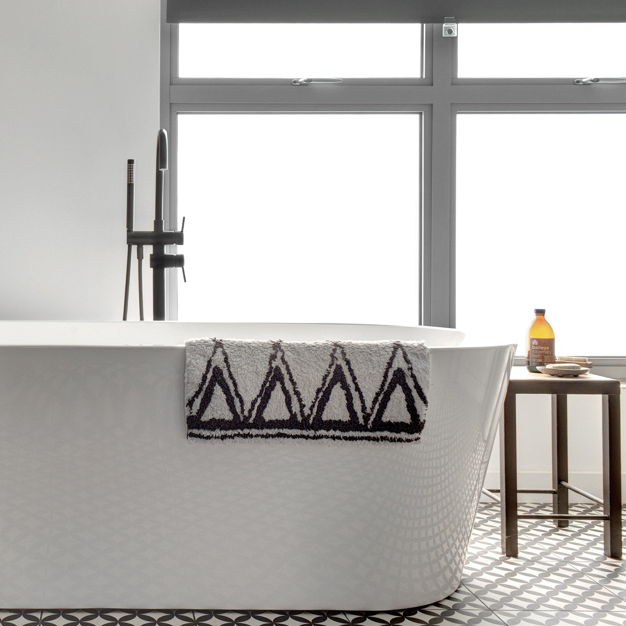 White bathroom with black and white towel