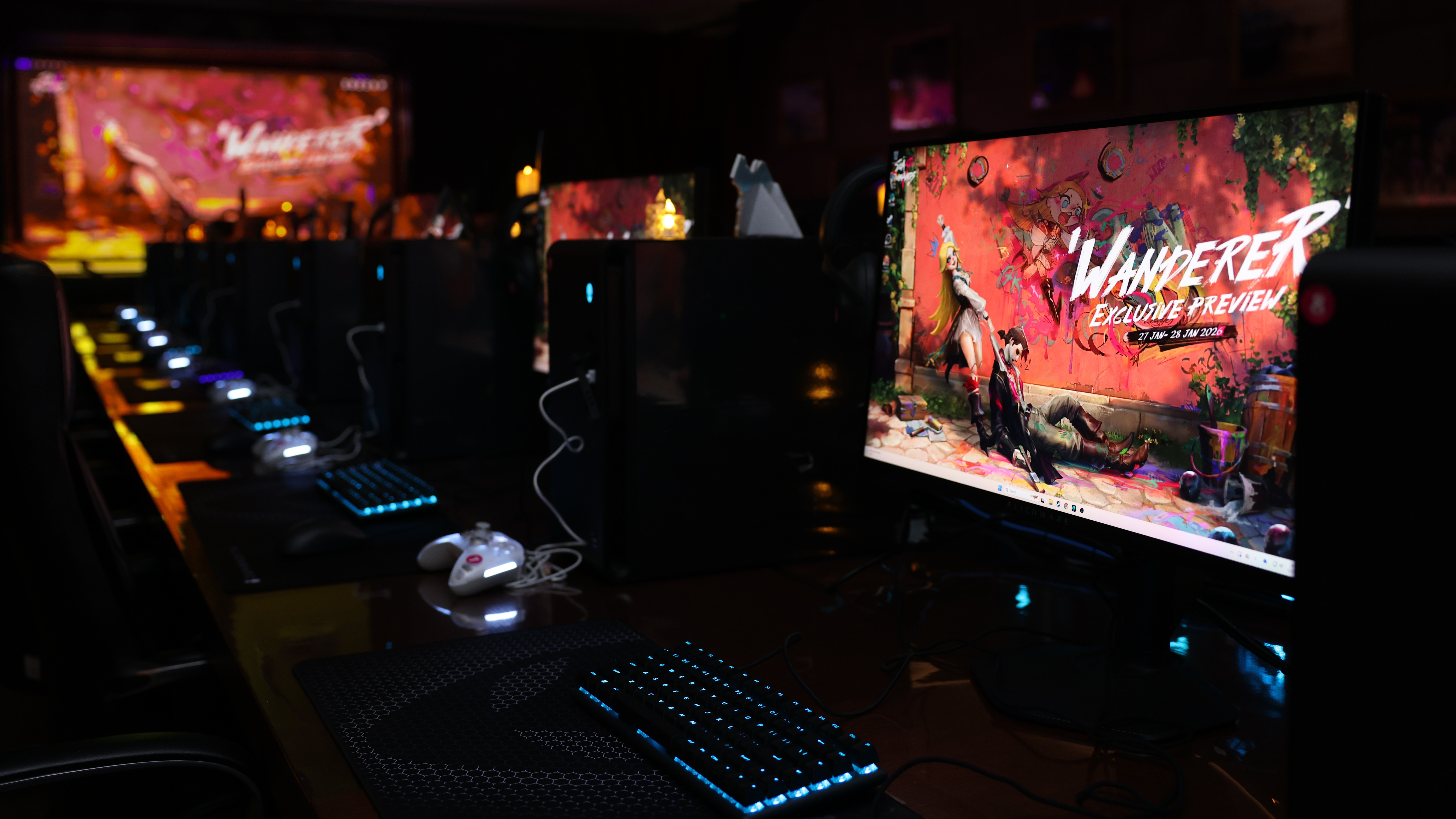 A photograph showing rows of gaming computers set up with an early build of Sea of Remnants in a darkened room.