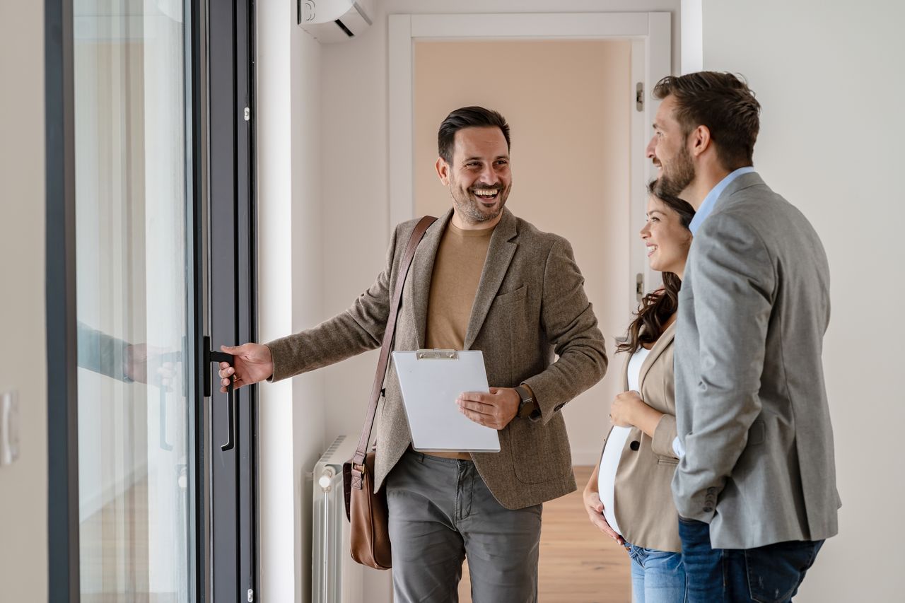 Estate agent showing viewers round property