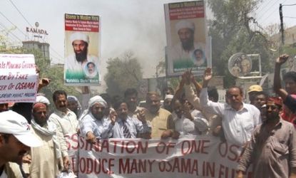Osama bin Laden supporters burn a replica of the American flag on Wednesday: Legal scholars are debating whether the U.S. killing of the 9/11 ringleader was in accordance with international l