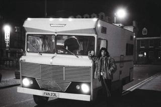 Freddie Mercury standing at the door of Queen'sWinnebago at night