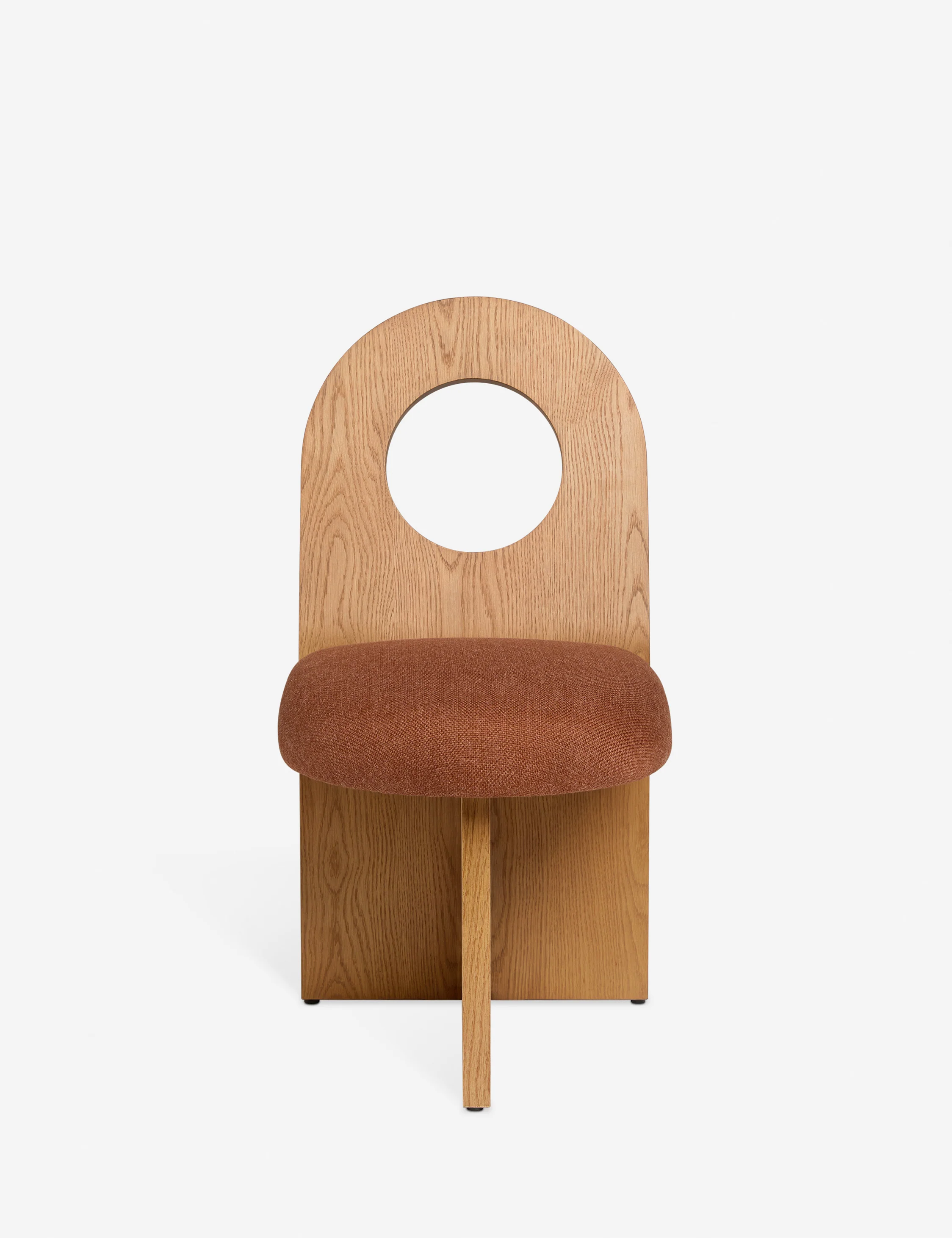 Lulu and Georgia sculptural wooden dining chair with circular cutout and light burgundy seat