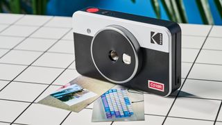 A black and gray Kodak Mini Shot 2 Retro 2-in-1 instant camera and printer