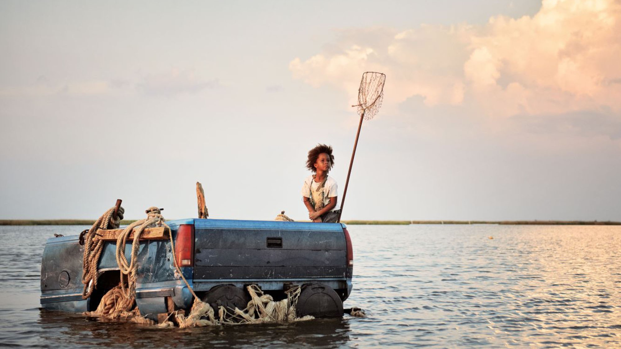 Quvenzhane Wallis sitting in a truck bed on floating on water in Beasts of the Southern Wild
