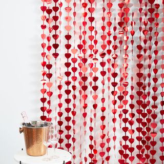 room with white wall and heart shape with garlands