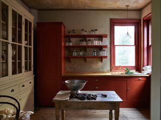 rustic style kitchen burgundy cabinetry and farmhouse table