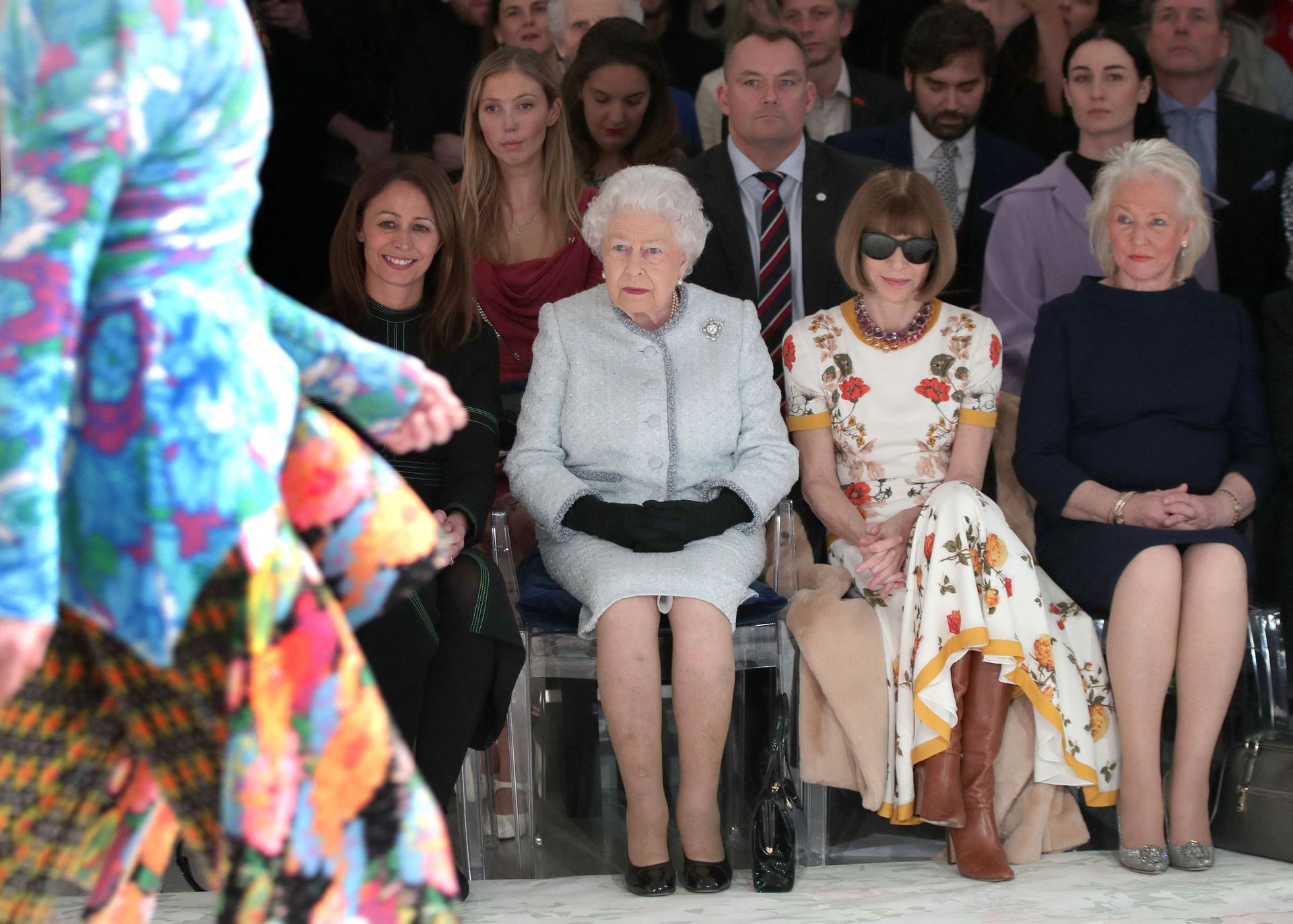 Queen Elizabeth, Anna Wintour and Angela Kelly sitting in the front row at a fashion show
