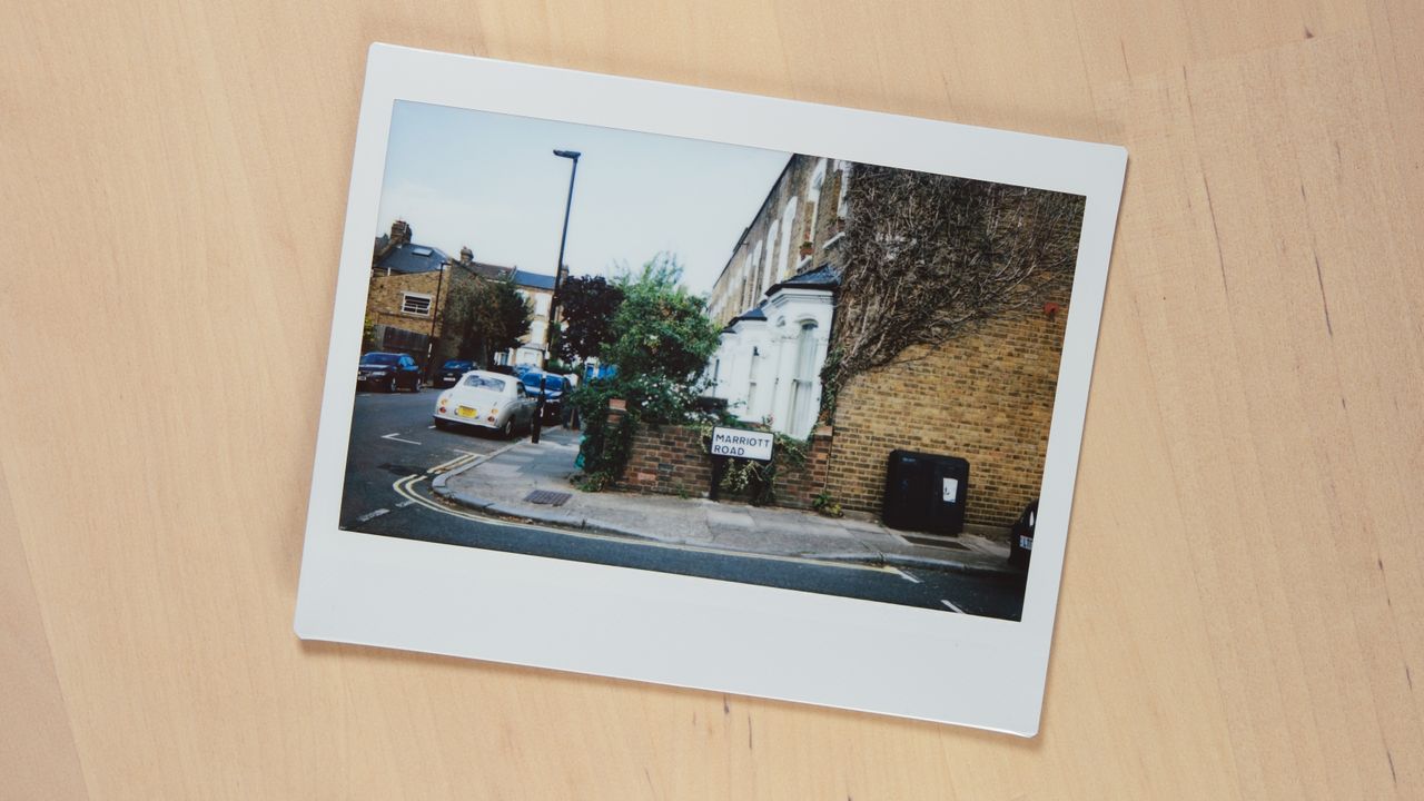Instax Wide prints laid out on a wooden surface