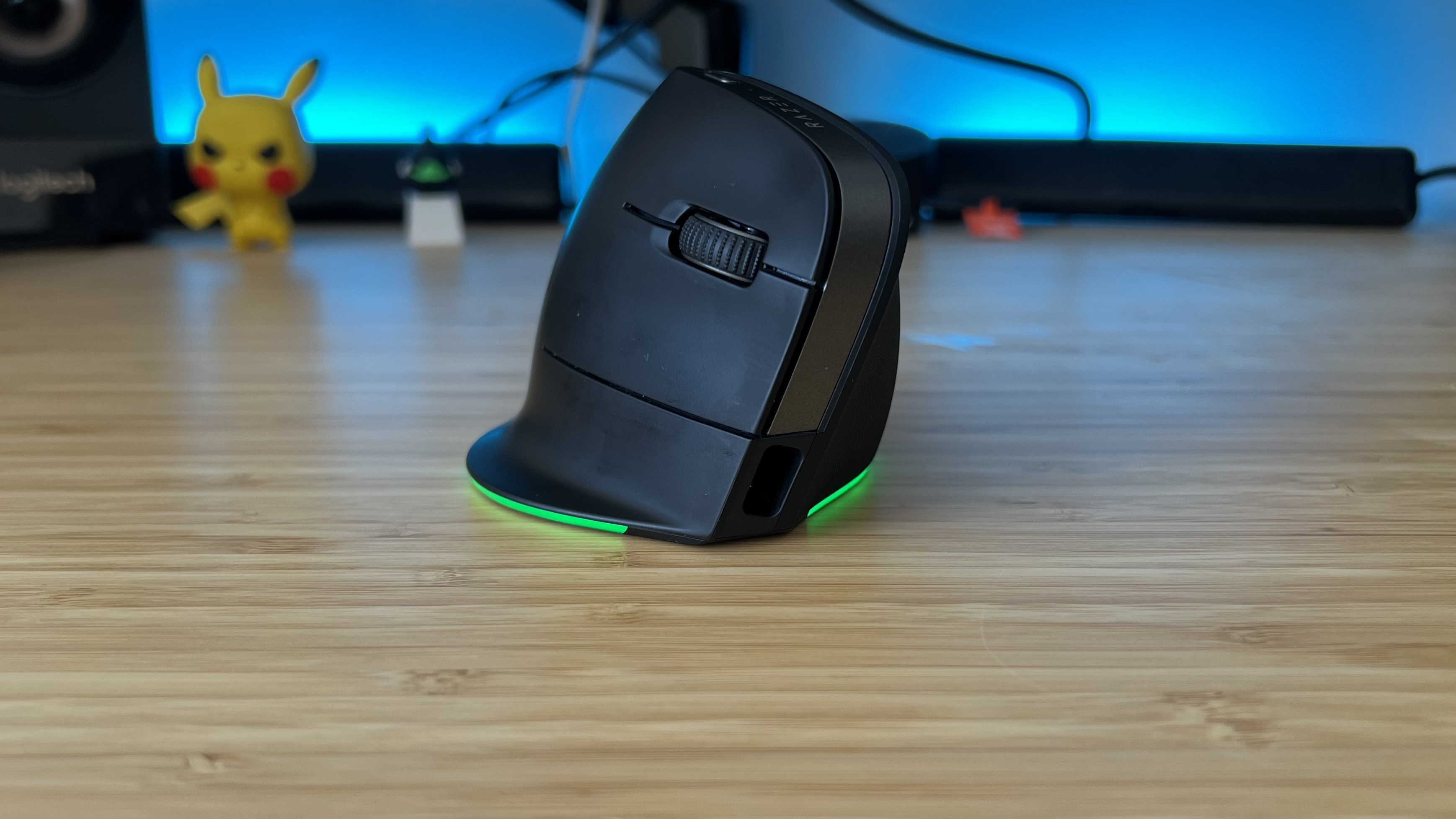 Razer Pro Click V2 Vertical Edition on a wooden desk with blue lighting in the background