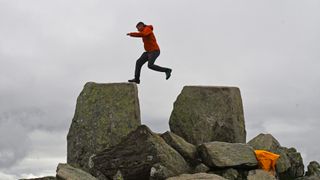 Man jumps Adam and Eve in Snowdonia wearing Salewa Mountain Trainer 2 Gore-Tex