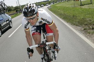 Andre Greipel chases back on from the caravan