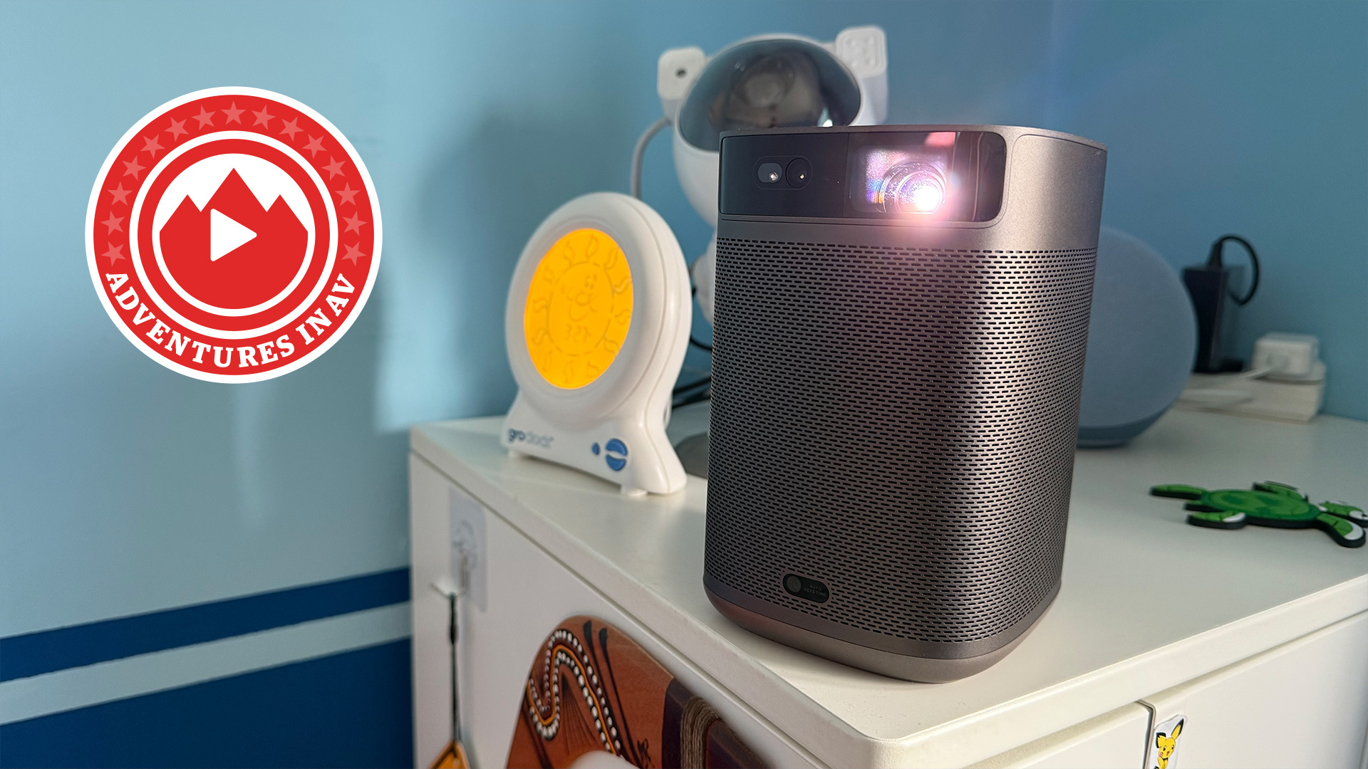 A photo of the Mogo 2 Pro portable projector standing on a small wardrobe in a child&#039;s bedroom
